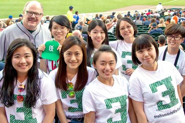 International students at a Detroit baseball game with the president.